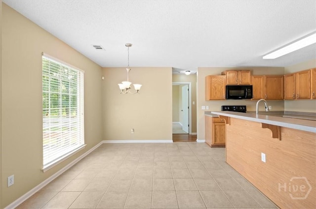 10 Cassidy Ct, Pooler, GA 31322 - kitchen with black microwave, a chandelier, light countertops, a kitchen breakfast bar, and hanging light fixtures