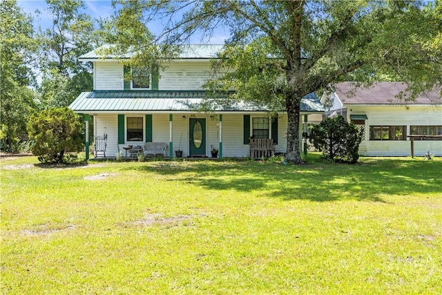 675 Foxwood Cir, Jesup, GA 31545 - view of front of house featuring a porch, a metal roof, and a front yard