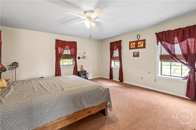 675 Foxwood Cir, Jesup, GA 31545 - carpeted bedroom featuring multiple windows, a ceiling fan, and a textured ceiling