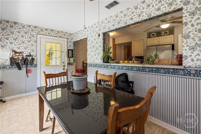 675 Foxwood Cir, Jesup, GA 31545 - dining space with wallpapered walls, a ceiling fan, and a textured ceiling
