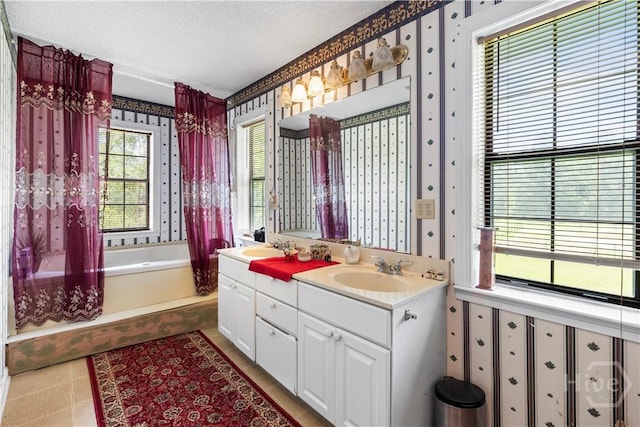 675 Foxwood Cir, Jesup, GA 31545 - bathroom featuring wallpapered walls, double vanity, a garden tub, and a textured ceiling