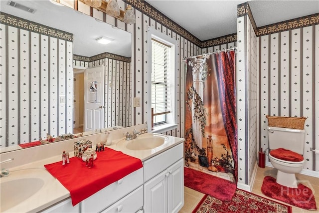 675 Foxwood Cir, Jesup, GA 31545 - bathroom with wallpapered walls, double vanity, curtained shower, and tile patterned floors