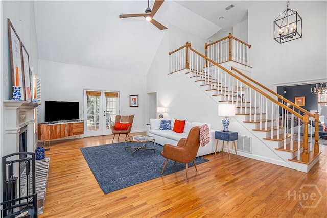 8720 Ferguson Ave, Savannah, GA 31406 - living room with high vaulted ceiling, stairs, wood finished floors, a chandelier, and a ceiling fan