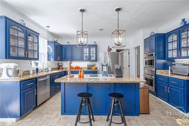 8720 Ferguson Ave, Savannah, GA 31406 - kitchen with blue cabinetry, a center island, a chandelier, a breakfast bar area, and appliances with stainless steel finishes