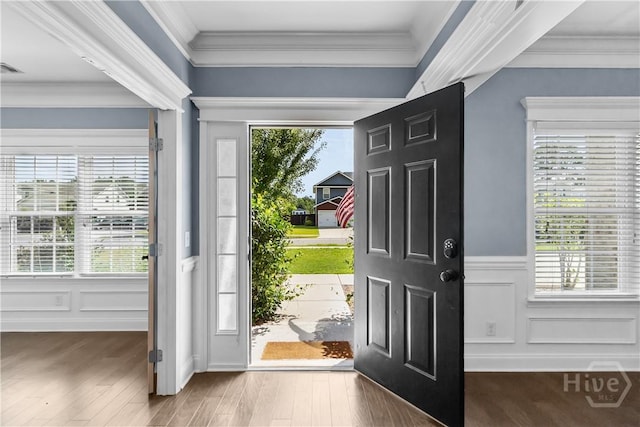 85 Wicklow Dr, Richmond Hill, GA 31324 - entrance foyer featuring crown molding, a wainscoted wall, wood finished floors, and a decorative wall