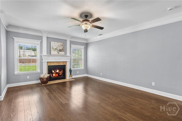 85 Wicklow Dr, Richmond Hill, GA 31324 - unfurnished living room featuring healthy amount of natural light, a tiled fireplace, a ceiling fan, dark wood finished floors, and crown molding