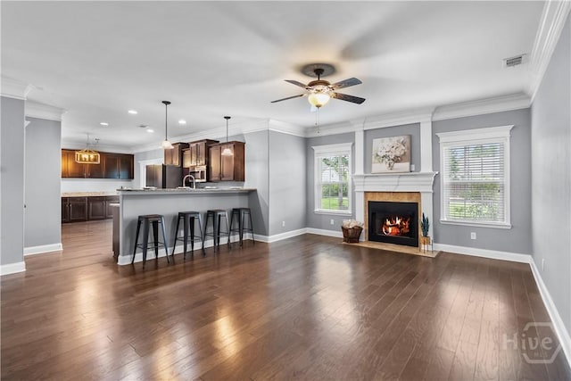 85 Wicklow Dr, Richmond Hill, GA 31324 - living room featuring a lit fireplace, dark wood finished floors, ceiling fan, recessed lighting, and crown molding