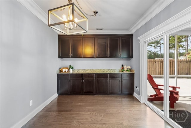 85 Wicklow Dr, Richmond Hill, GA 31324 - bar with a chandelier, ornamental molding, wood finished floors, and decorative light fixtures