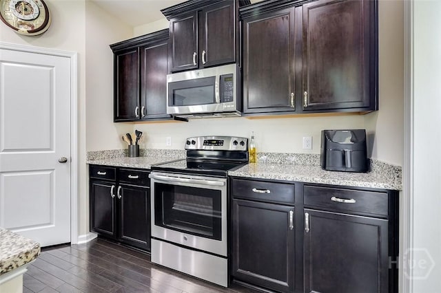 353 Casey Dr, Pooler, GA 31322 - kitchen featuring appliances with stainless steel finishes, dark wood-style floors, light stone countertops, and dark brown cabinets