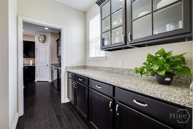 353 Casey Dr, Pooler, GA 31322 - kitchen featuring dark wood-style floors, glass insert cabinets, light stone countertops, and dark cabinetry