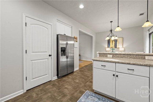 130 Whirlwind Way, Guyton, GA 31312 - kitchen with stainless steel refrigerator with ice dispenser, white cabinets, pendant lighting, and a chandelier
