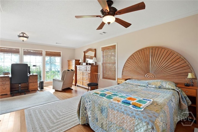 245 Youmans Rd, Midway, GA 31320 - bedroom featuring ornamental molding, light wood-style flooring, a desk, and ceiling fan