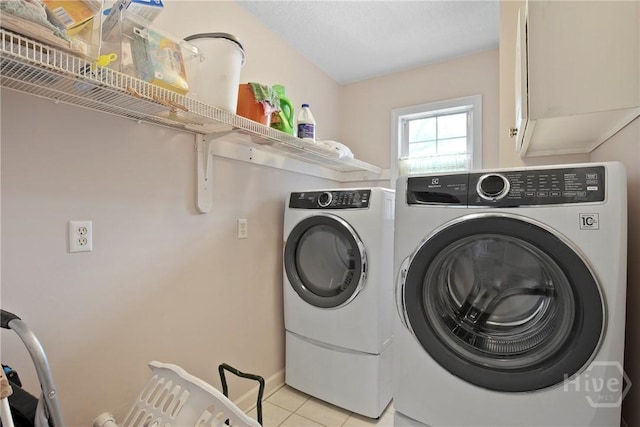 245 Youmans Rd, Midway, GA 31320 - laundry room featuring separate washer and dryer, light tile patterned floors, and cabinet space