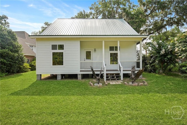 245 Youmans Rd, Midway, GA 31320 - view of front of property featuring covered porch, a front lawn, and a metal roof