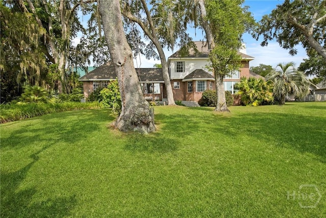 245 Youmans Rd, Midway, GA 31320 - view of front of house with a front lawn