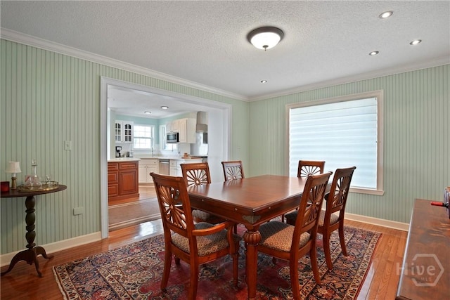 245 Youmans Rd, Midway, GA 31320 - dining space featuring crown molding, light wood finished floors, and a textured ceiling