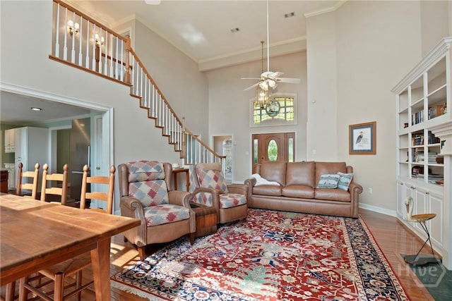 245 Youmans Rd, Midway, GA 31320 - living room with a towering ceiling, wood finished floors, a ceiling fan, and stairs