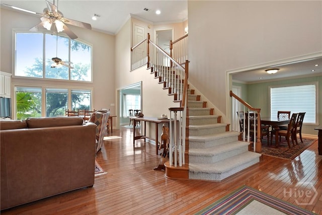 245 Youmans Rd, Midway, GA 31320 - stairway featuring a high ceiling, a ceiling fan, wood-type flooring, and ornamental molding