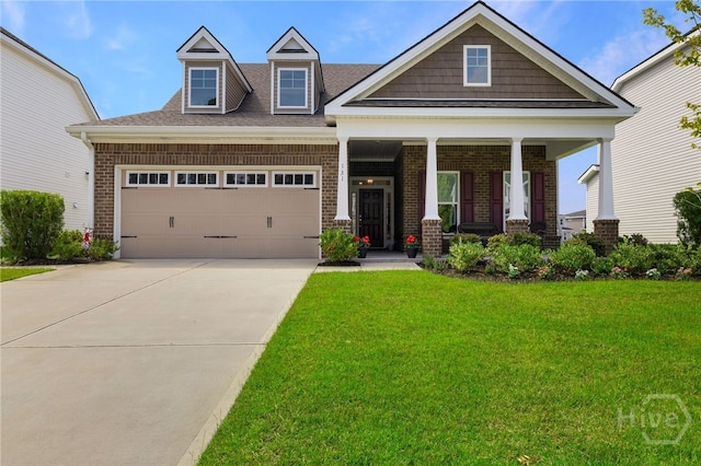 131 Como Dr, Pooler, GA 31322 - view of front of home with a front lawn, brick siding, a garage, covered porch, and driveway
