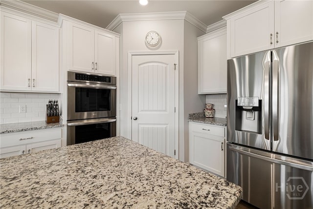 131 Como Dr, Pooler, GA 31322 - kitchen with stainless steel appliances, decorative backsplash, light stone counters, crown molding, and white cabinets