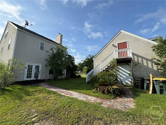 8 Fairgreen St, Savannah, GA 31407 - back of property featuring french doors, a lawn, and a chimney