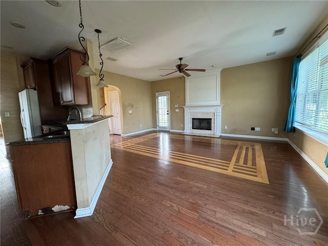8 Fairgreen St, Savannah, GA 31407 - kitchen featuring freestanding refrigerator, ceiling fan, dark wood-style floors, and a high end fireplace