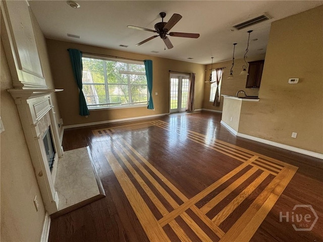 8 Fairgreen St, Savannah, GA 31407 - unfurnished living room featuring a glass covered fireplace, dark wood finished floors, and ceiling fan