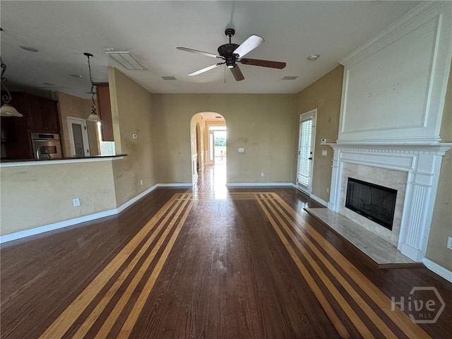 8 Fairgreen St, Savannah, GA 31407 - unfurnished living room featuring arched walkways, wood finished floors, ceiling fan, and a premium fireplace