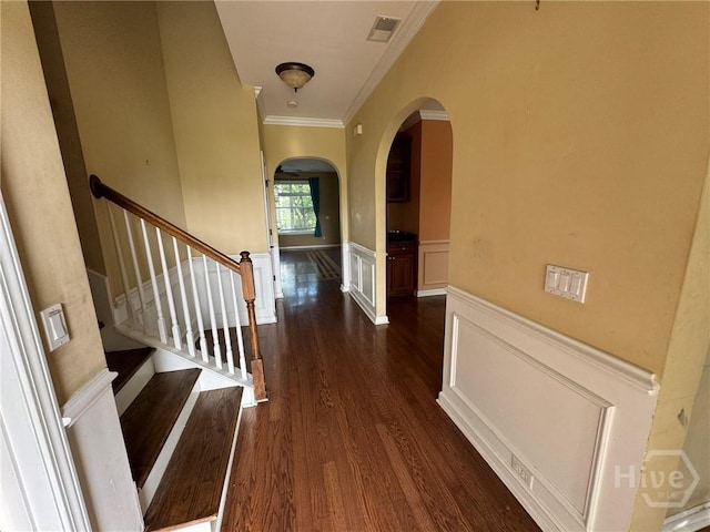 8 Fairgreen St, Savannah, GA 31407 - entryway featuring arched walkways, ornamental molding, wainscoting, dark wood finished floors, and stairway
