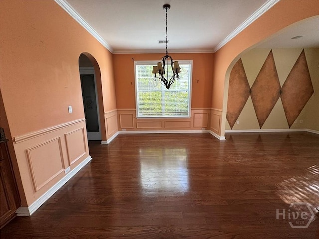 8 Fairgreen St, Savannah, GA 31407 - unfurnished dining area with dark wood-style floors, arched walkways, ornamental molding, a wainscoted wall, and a decorative wall
