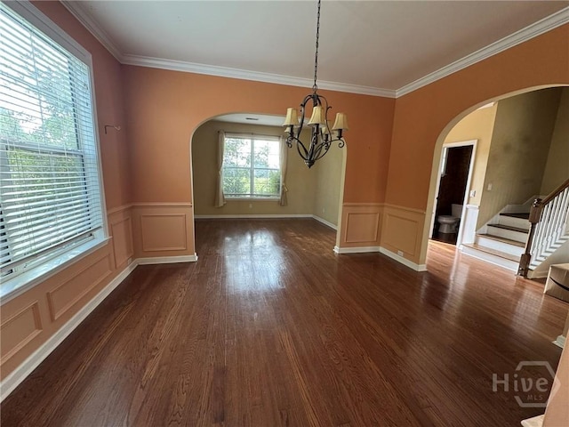8 Fairgreen St, Savannah, GA 31407 - unfurnished dining area featuring arched walkways, a chandelier, a wainscoted wall, a decorative wall, and dark wood-style floors