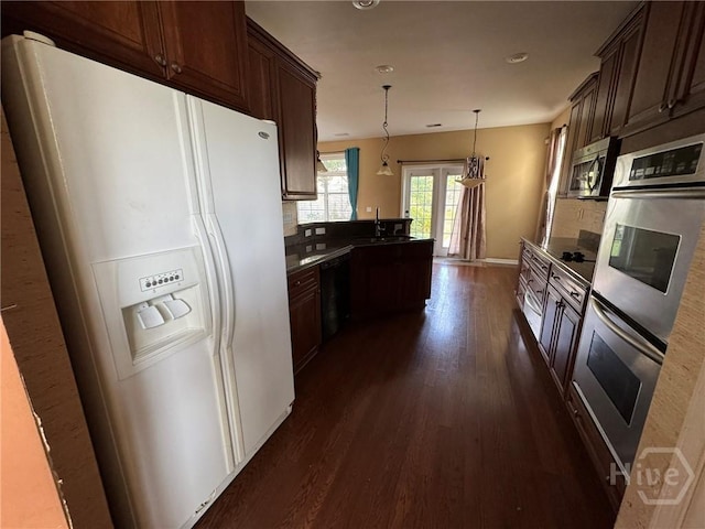 8 Fairgreen St, Savannah, GA 31407 - kitchen featuring stainless steel appliances, dark wood-style flooring, backsplash, a peninsula, and recessed lighting