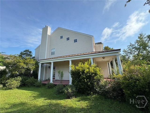 8 Fairgreen St, Savannah, GA 31407 - rear view of property with a yard, a porch, and a chimney