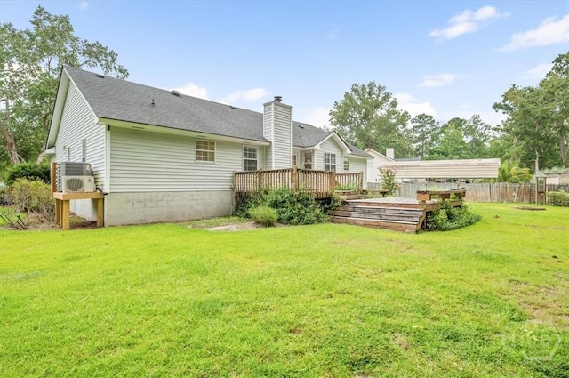 375 Hermitage Dr, Richmond Hill, GA 31324 - rear view of house featuring a wooden deck, a chimney, and roof with shingles