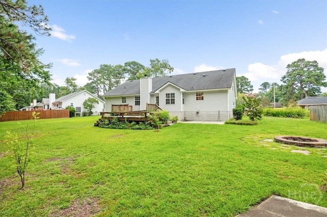 375 Hermitage Dr, Richmond Hill, GA 31324 - back of property featuring a deck, a fire pit, and a chimney