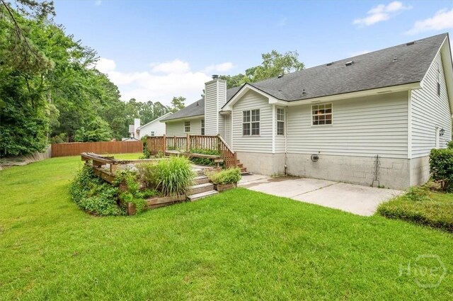 375 Hermitage Dr, Richmond Hill, GA 31324 - back of property featuring a patio, a shingled roof, and a chimney