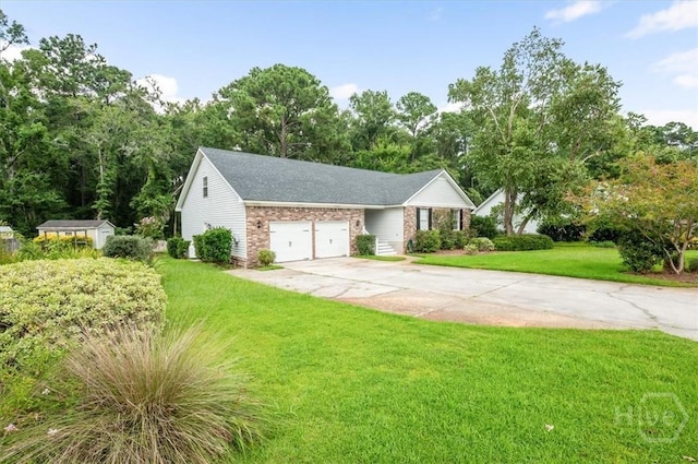 375 Hermitage Dr, Richmond Hill, GA 31324 - view of front of home featuring brick siding, driveway, a front yard, a garage, and view of wooded area