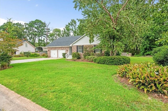 375 Hermitage Dr, Richmond Hill, GA 31324 - ranch-style home featuring concrete driveway, a garage, a front yard, and brick siding