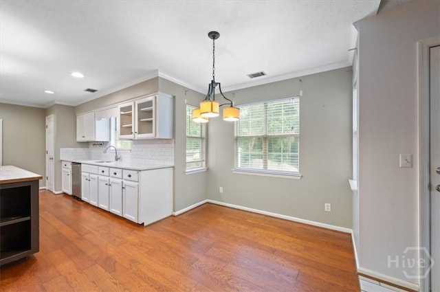 375 Hermitage Dr, Richmond Hill, GA 31324 - kitchen featuring dishwasher, wood finished floors, light countertops, white cabinetry, and glass insert cabinets
