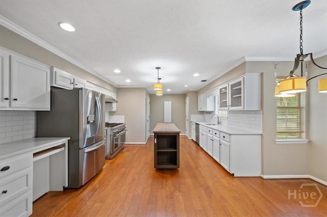375 Hermitage Dr, Richmond Hill, GA 31324 - kitchen featuring stainless steel appliances, light countertops, white cabinets, tasteful backsplash, and glass insert cabinets