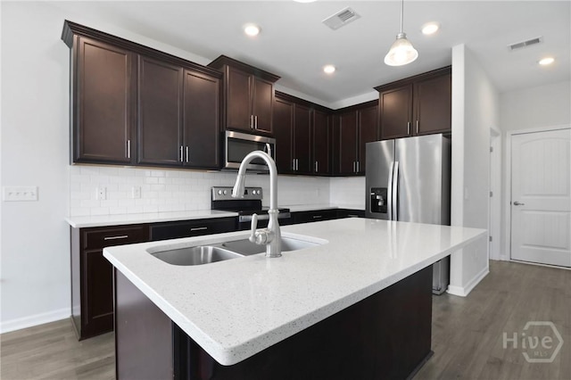 106 Brookline Dr, Savannah, GA 31407 - kitchen with stainless steel appliances, wood finished floors, decorative backsplash, pendant lighting, and dark brown cabinetry
