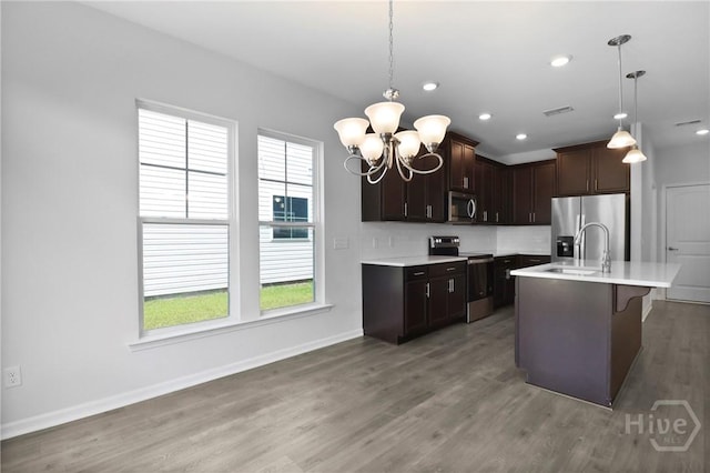 106 Brookline Dr, Savannah, GA 31407 - kitchen featuring stainless steel appliances, light countertops, a chandelier, light wood-type flooring, and pendant lighting