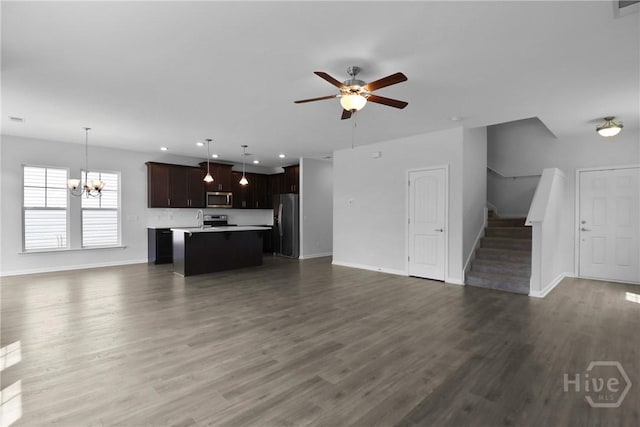 106 Brookline Dr, Savannah, GA 31407 - unfurnished living room featuring a chandelier, ceiling fan, stairway, dark wood-style flooring, and recessed lighting
