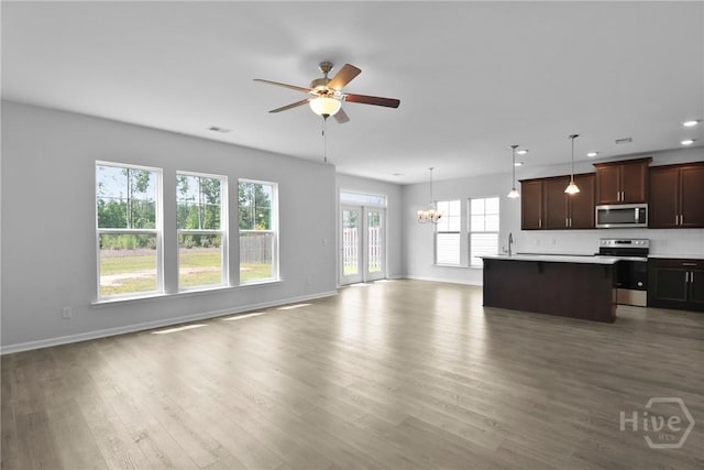 106 Brookline Dr, Savannah, GA 31407 - kitchen featuring appliances with stainless steel finishes, open floor plan, ceiling fan, a chandelier, and wood finished floors