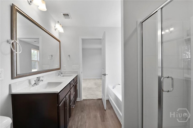 106 Brookline Dr, Savannah, GA 31407 - full bath with double vanity, a garden tub, wood finished floors, and a stall shower