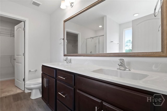 106 Brookline Dr, Savannah, GA 31407 - full bathroom with wood finished floors, double vanity, a shower stall, and a spacious closet
