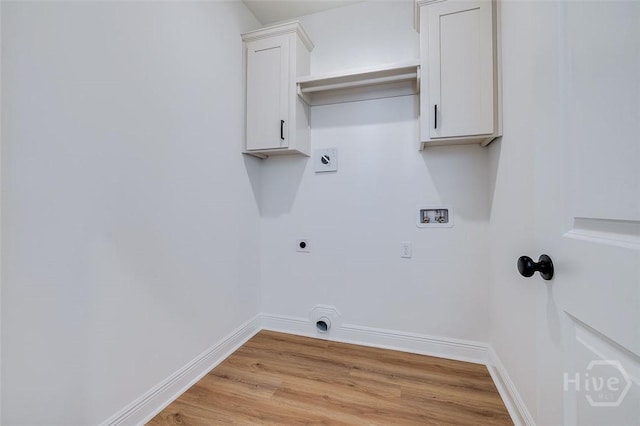 201 Dean Dr, Guyton, GA 31312 - washroom with hookup for an electric dryer, light wood finished floors, washer hookup, and cabinet space