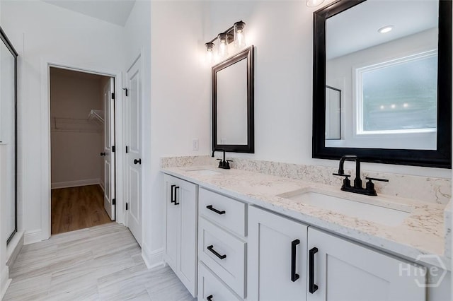 201 Dean Dr, Guyton, GA 31312 - bathroom featuring double vanity, a walk in closet, and a shower with shower door