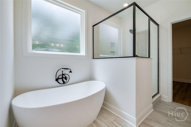 201 Dean Dr, Guyton, GA 31312 - bathroom featuring a shower stall, a freestanding tub, and a walk in closet