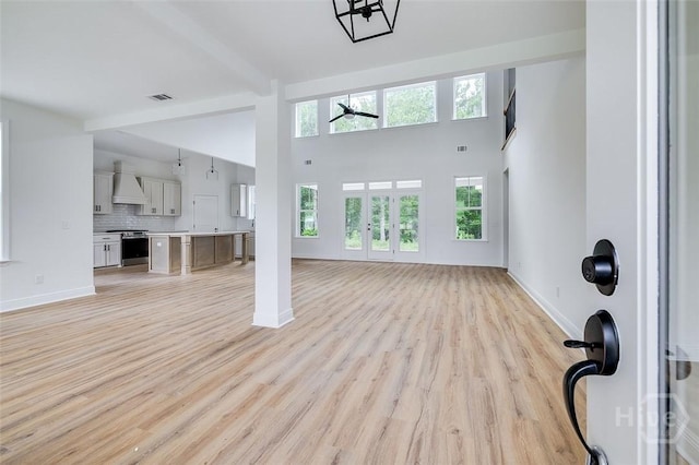 201 Dean Dr, Guyton, GA 31312 - unfurnished living room with light wood finished floors, a high ceiling, and ceiling fan